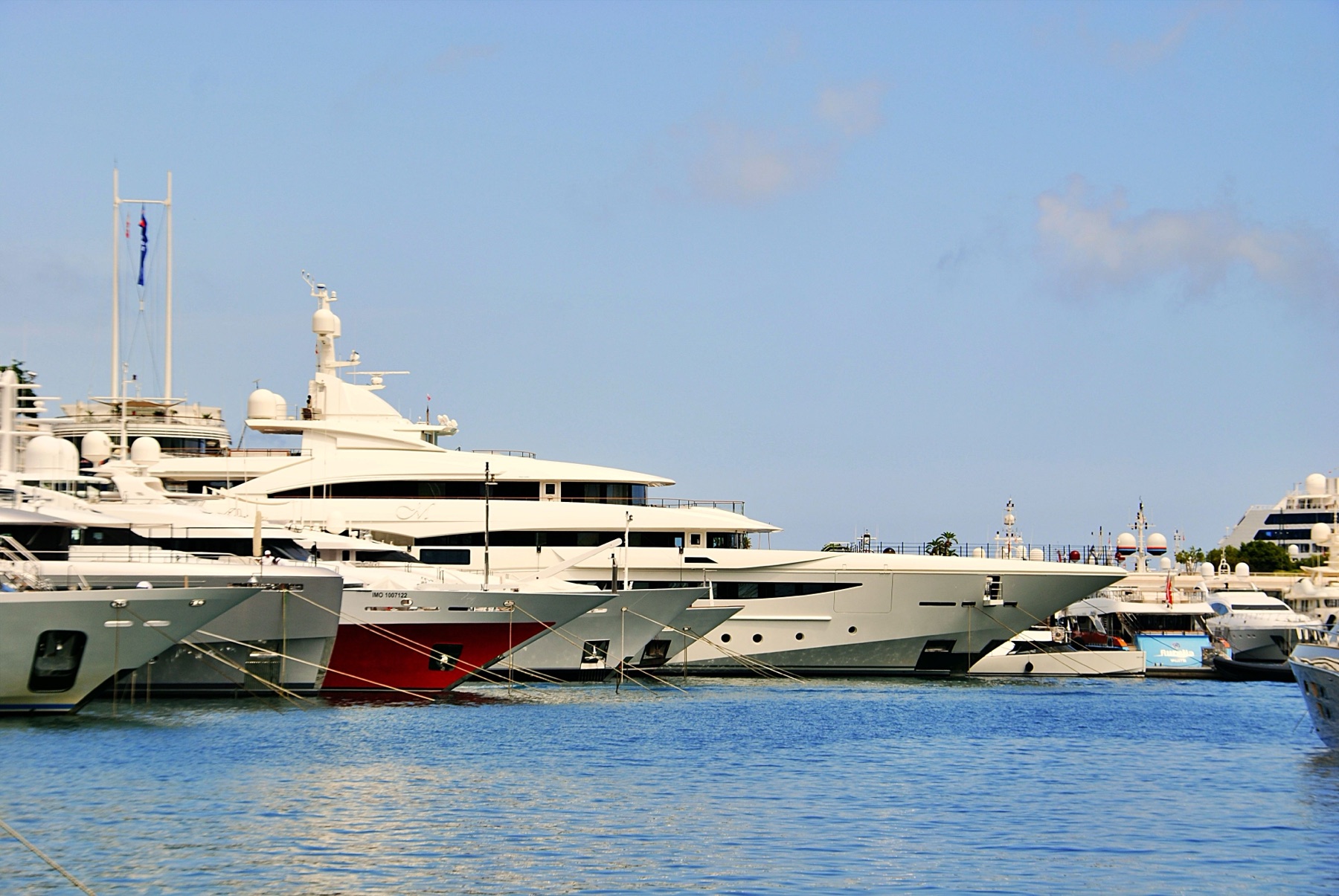 yachts à moteur amarrés côte à côte dans un port de plaisance ensoleillé de la Côte d'Azur